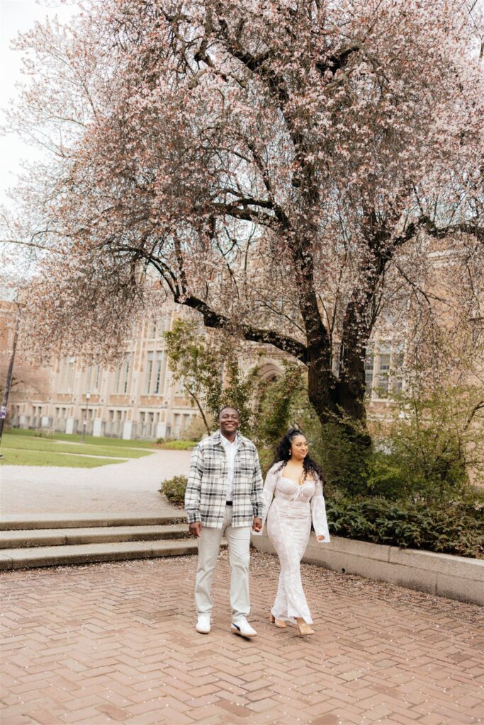 cute couple walking around the university of washington during their photoshoot 