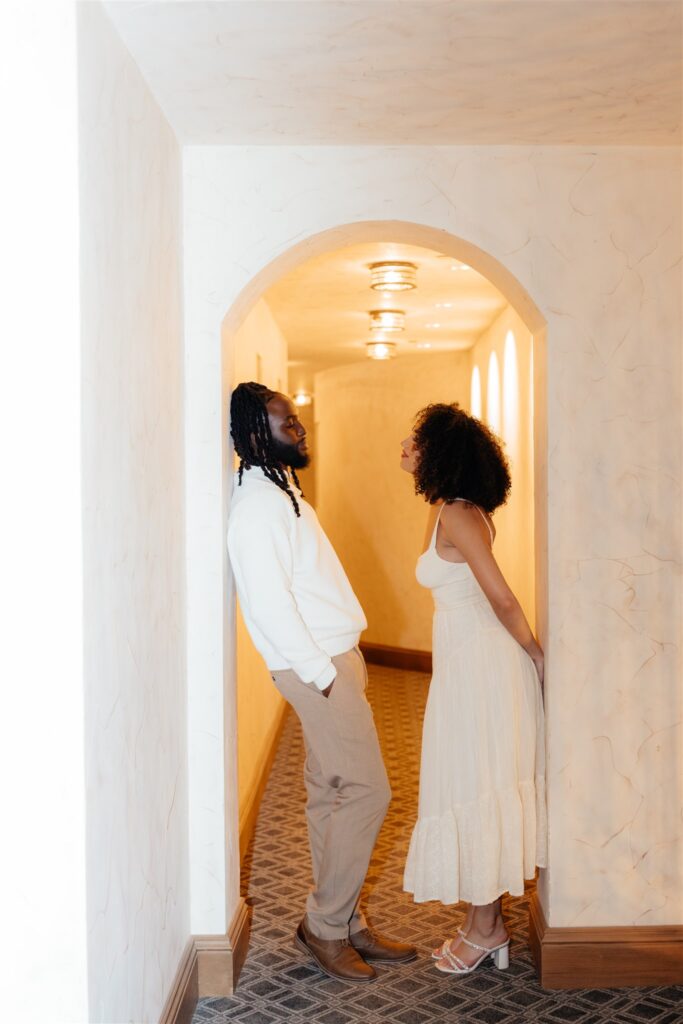 couple smiling at each other during their session