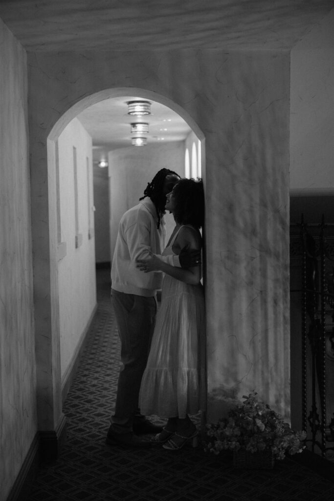 cute picture of the newly engaged couple kissing during their photoshoot