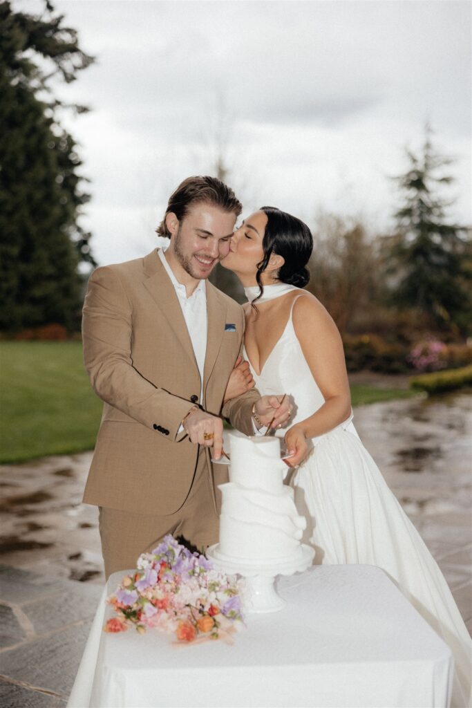 bride kissing the groom on the cheek