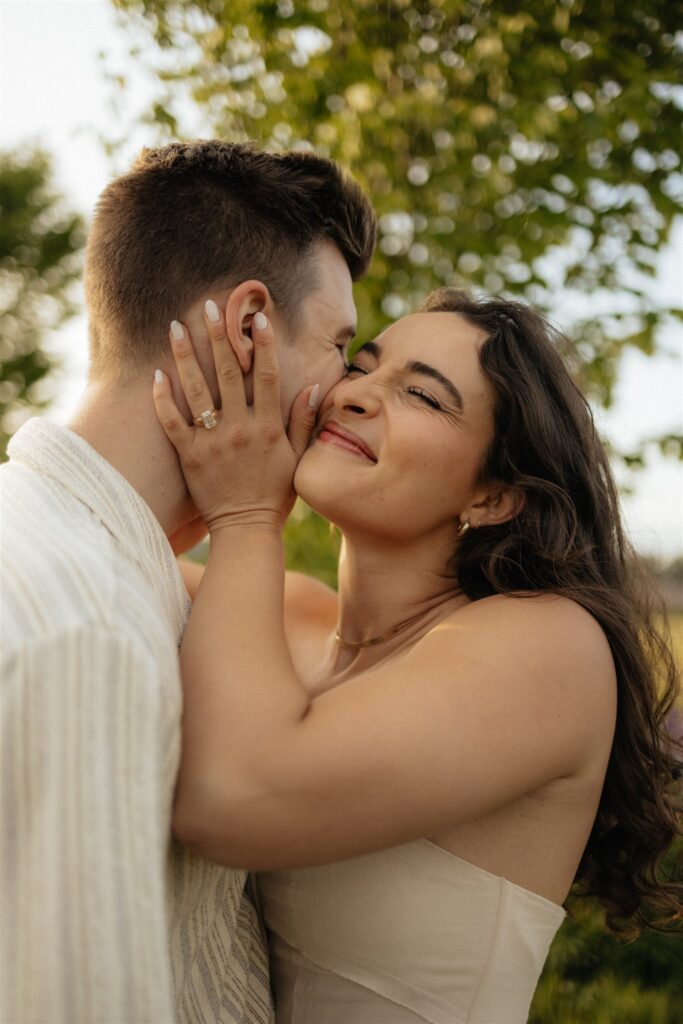 fiance kissing his fiance on the cheek