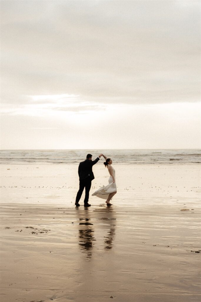 newlyweds dancing at the beach during their elopement session