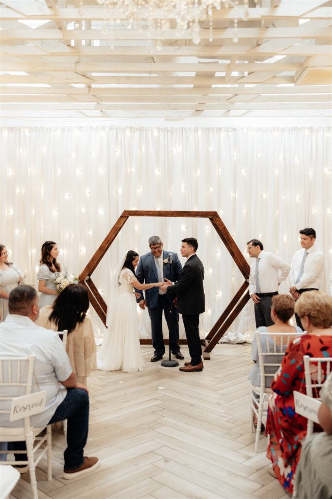 cute couple holding hands during their ceremony