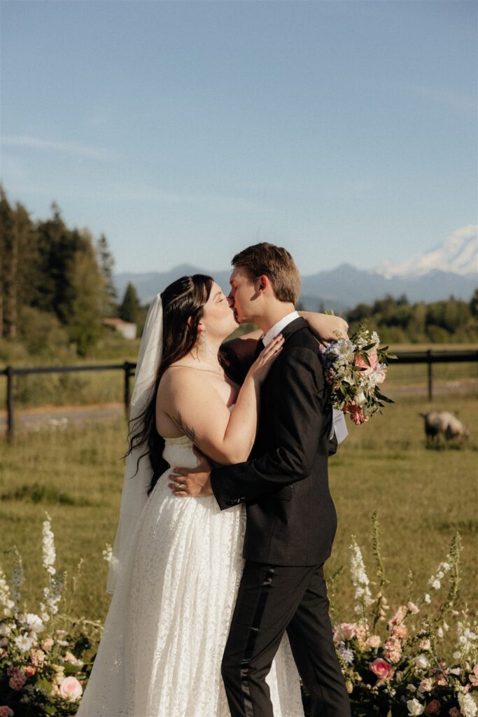 cute picture of the bride and groom kissing after their ceremony