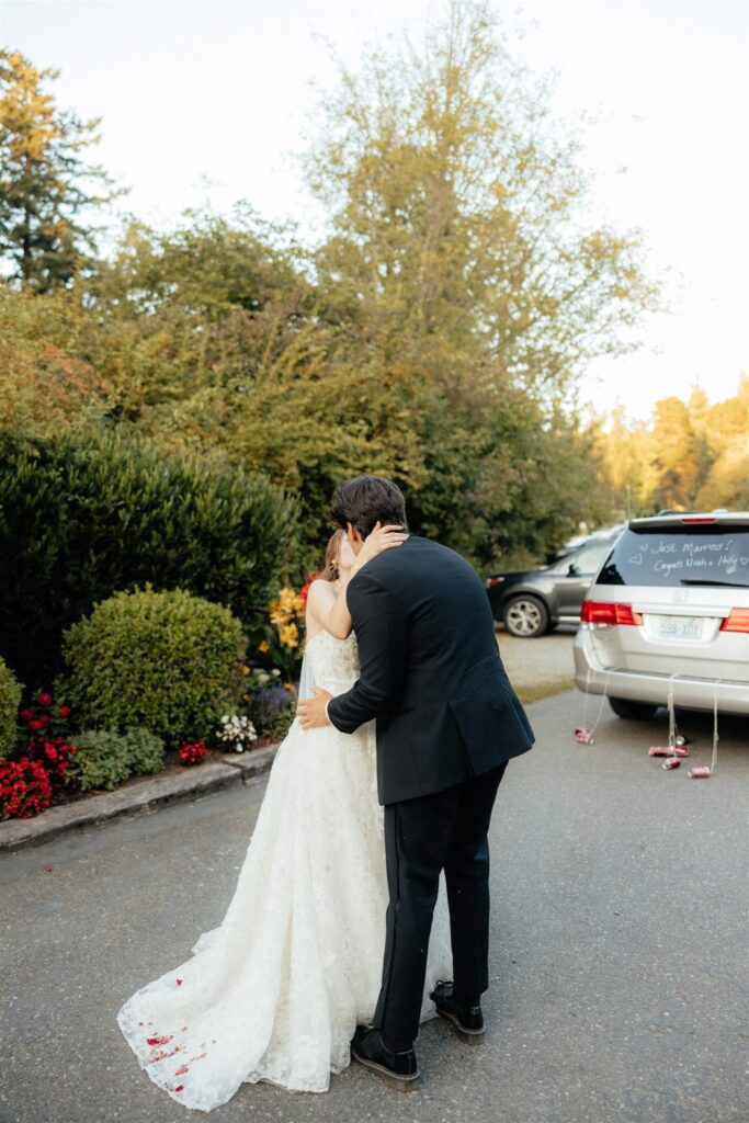 Newly married couple kissing after their reception party