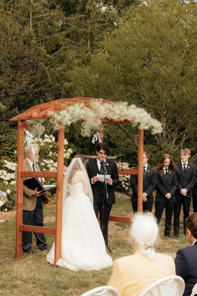 Bride and groom holding hands during their ceremony