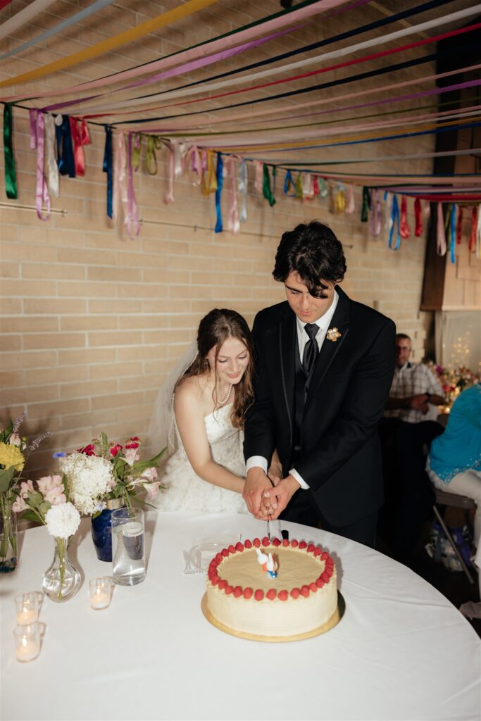 Bride and groom, cutting their wedding cake