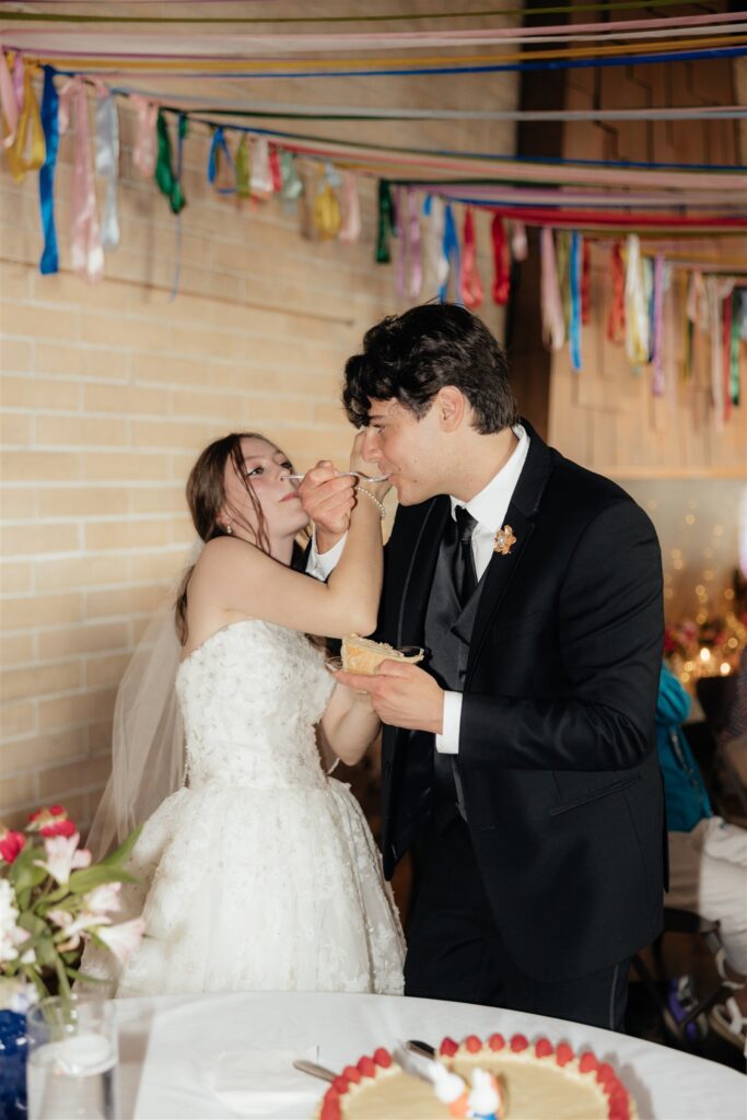 Newly married couple trying their wedding cake