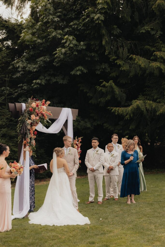 bride and groom holding hands during their wedding ceremony