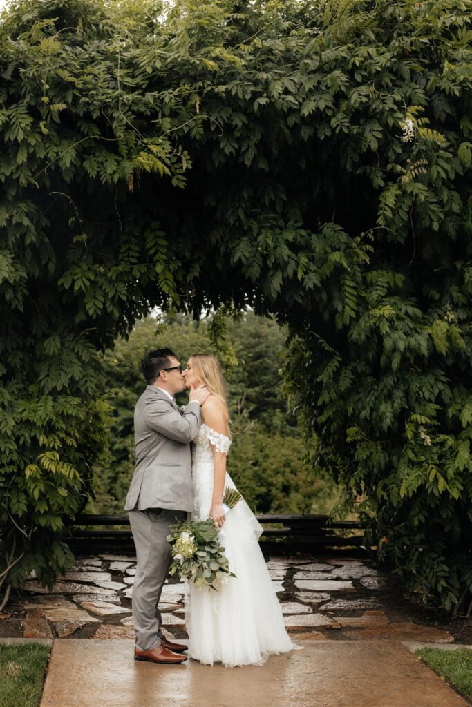 Portrait of the bride and groom kiss