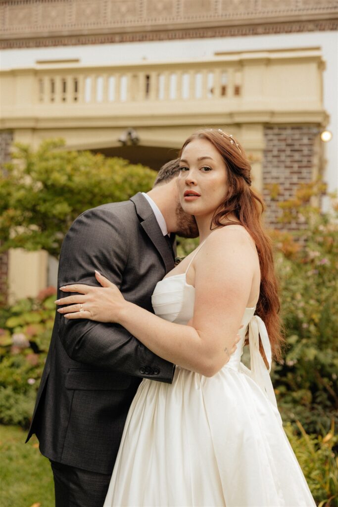 groom kissing the bride on the cheek