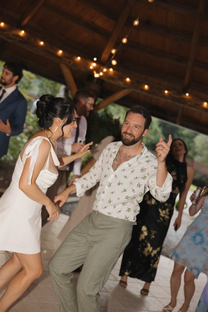 newlyweds having the best time at their wedding reception