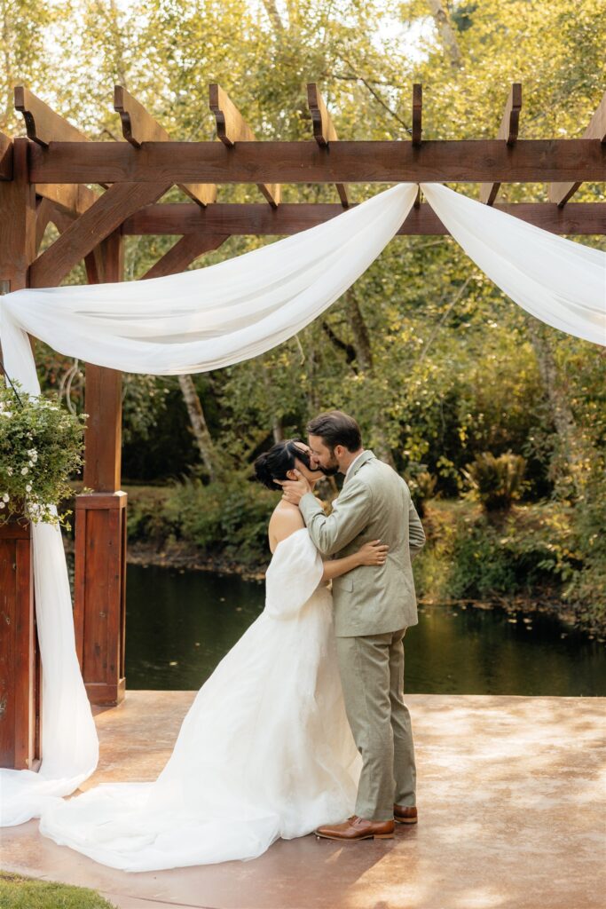 bride and groom kissing after their ceremony