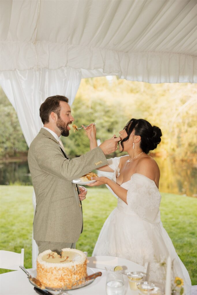 newly married couple trying their wedding cake