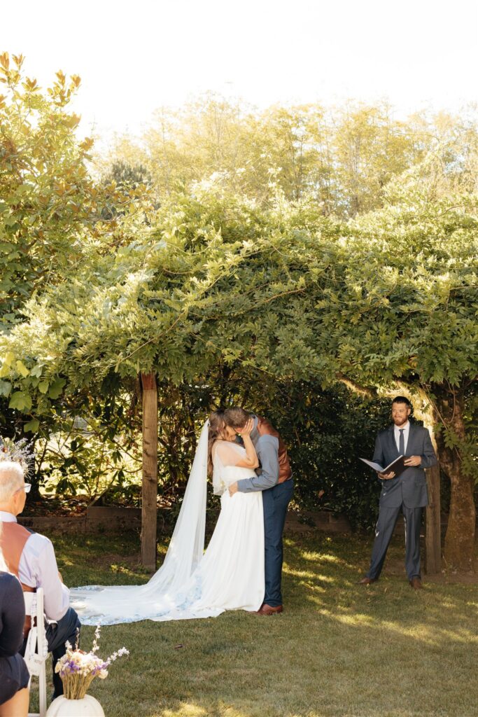 portrait of the newlyweds kissing after their ceremony