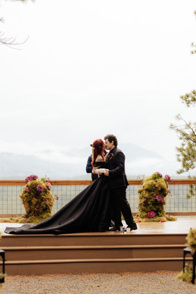 Portrait of the bride and groom, kissing after their wedding ceremony
