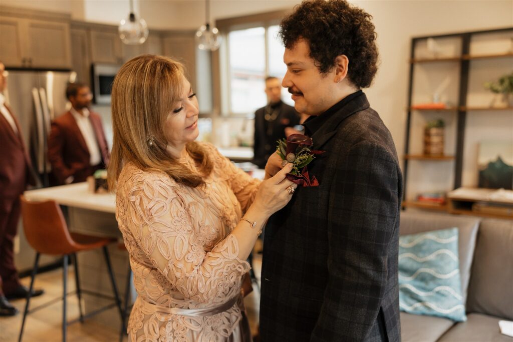 Mother of the groom, helping him before the ceremony