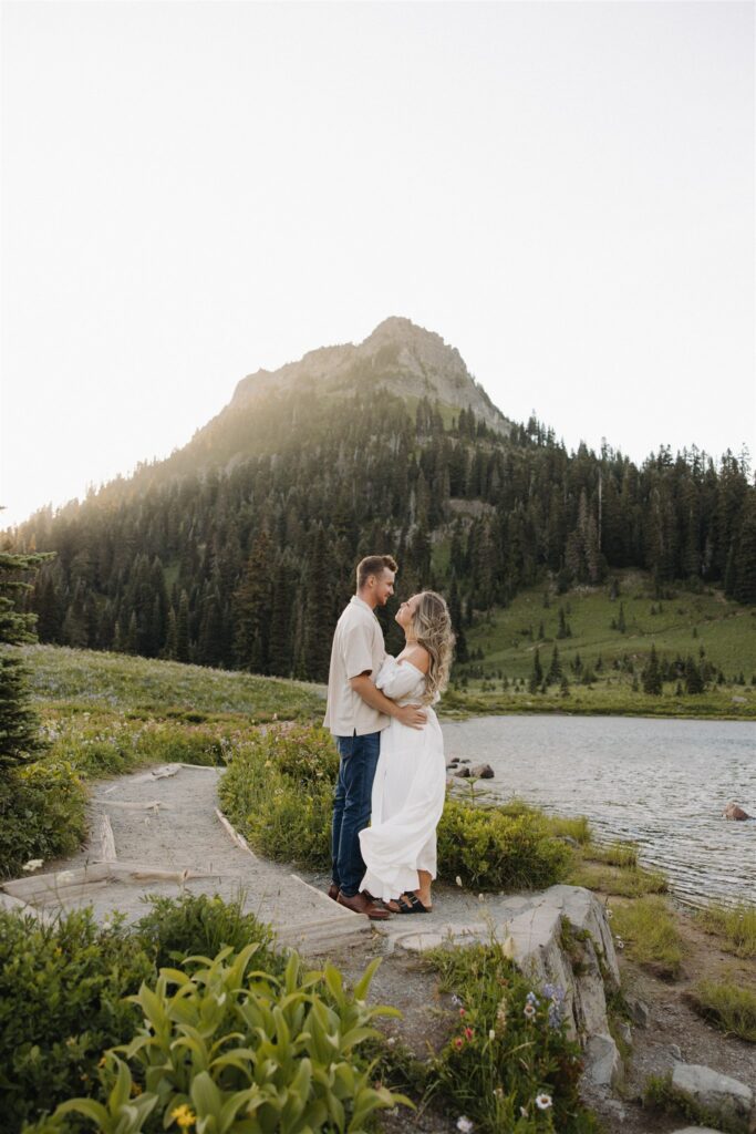 newly engaged couple smiling at each other during their photoshoot