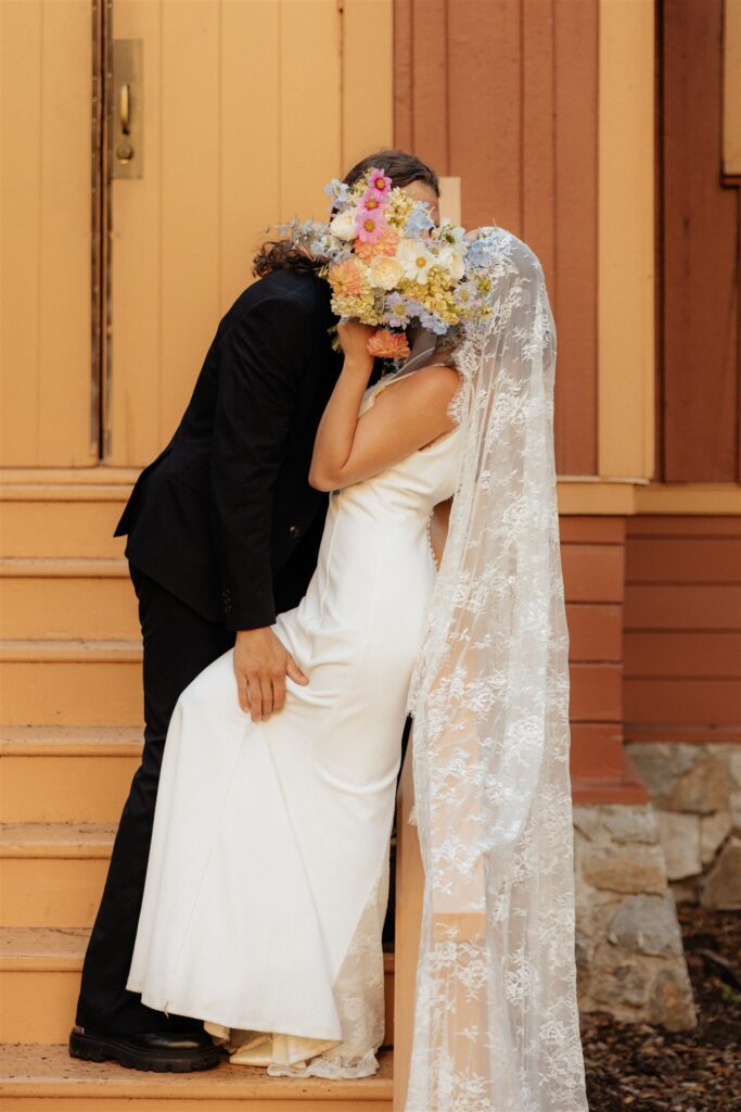 Portrait of the newly married couple kissing after their ceremony