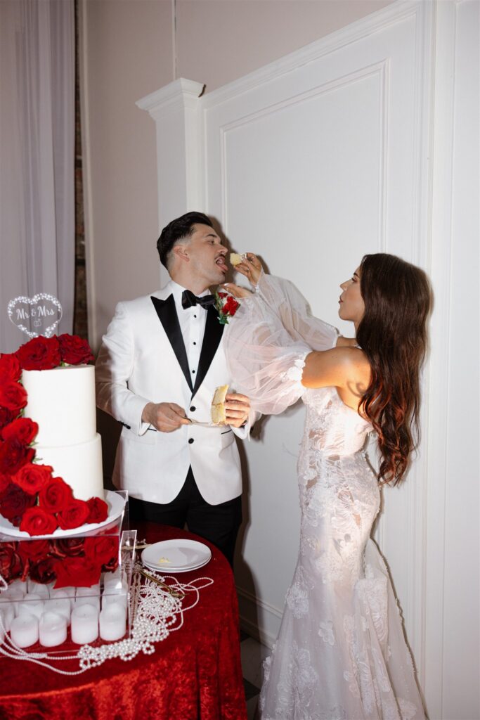 newlyweds trying their wedding cake