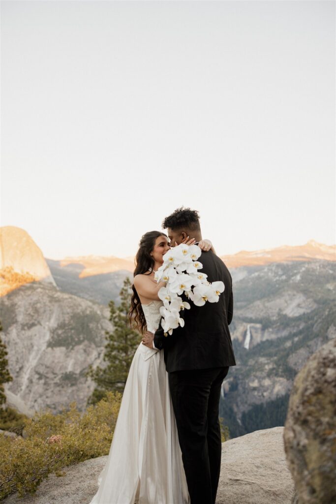 portrait of the bride and groom kissing during their bridal photos