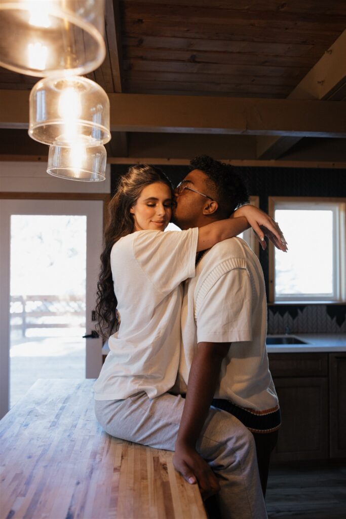 groom kissing the bride on the forehead
