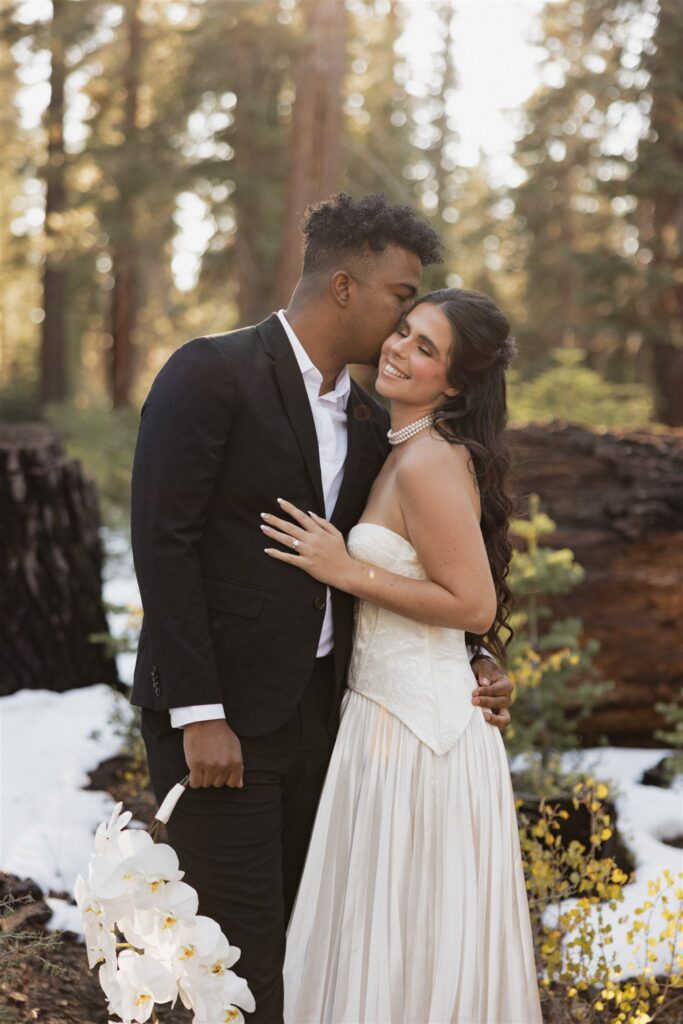 groom kissing the bride on the cheek