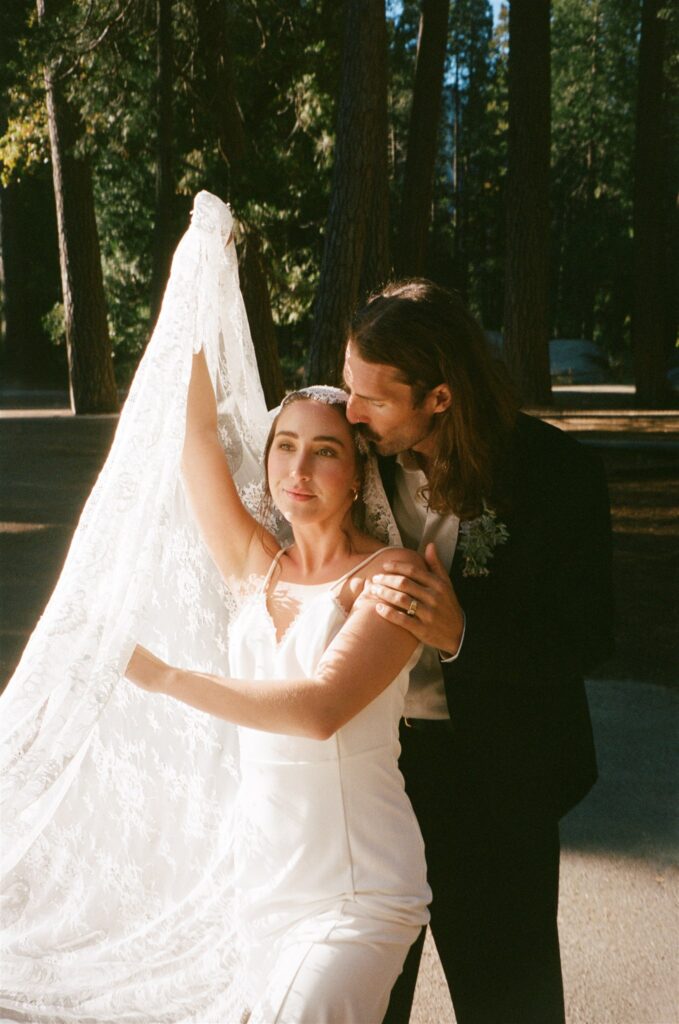 groom kissing the bride on the forehead