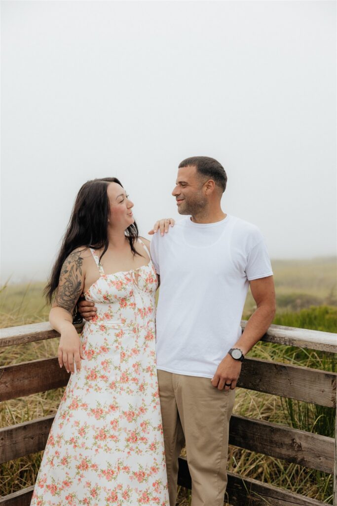 cute picture of the newly engaged couple smiling at each other