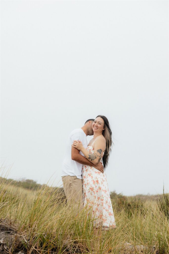 fiance kissing his fiance on the cheek during their photoshoot