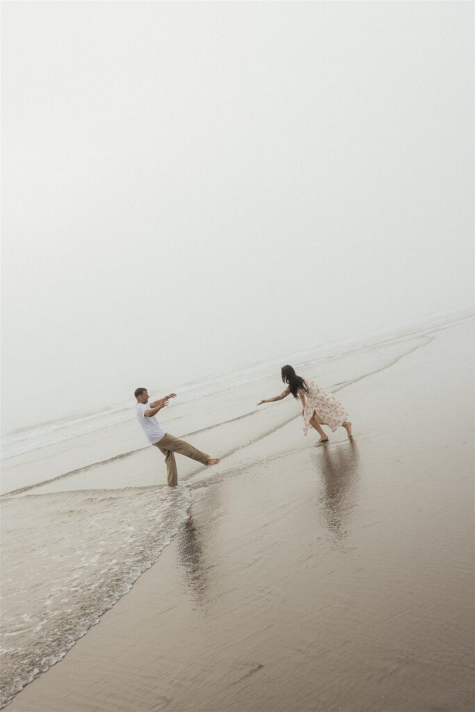 playful couple session at the beach