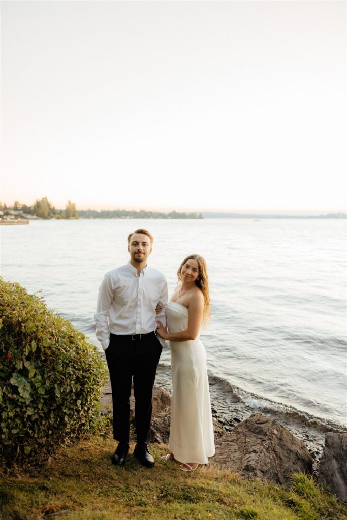 newly engaged couple smiling at the camera during their photoshoot