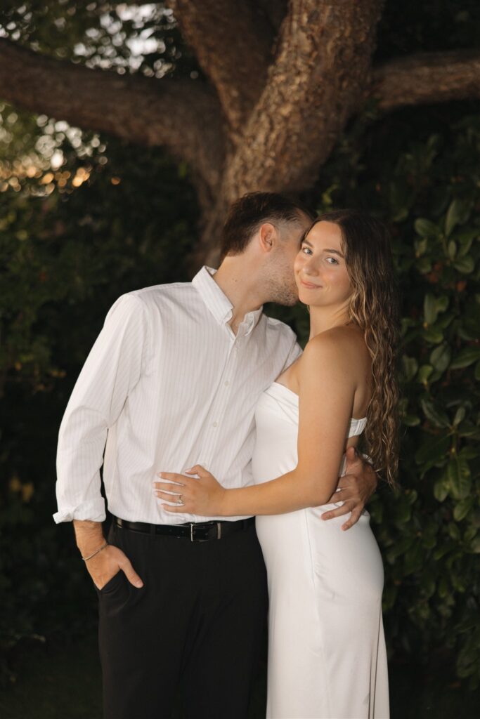 fiance kissing his fiance on the cheek