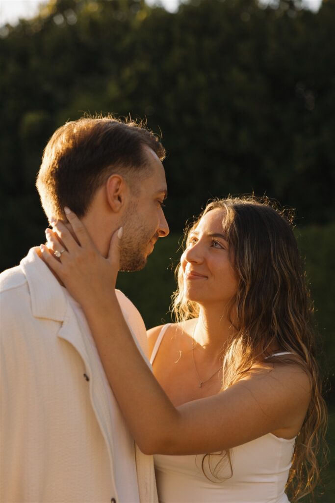 cute picture of the newly engaged couple smiling at each other