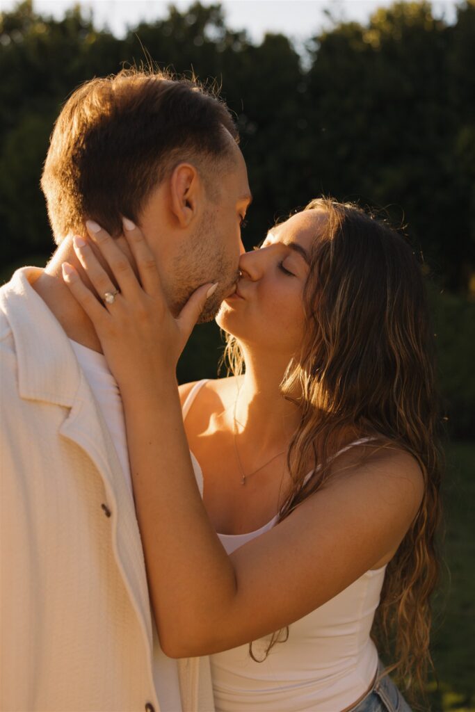 cute picture of the newly engaged couple kissing