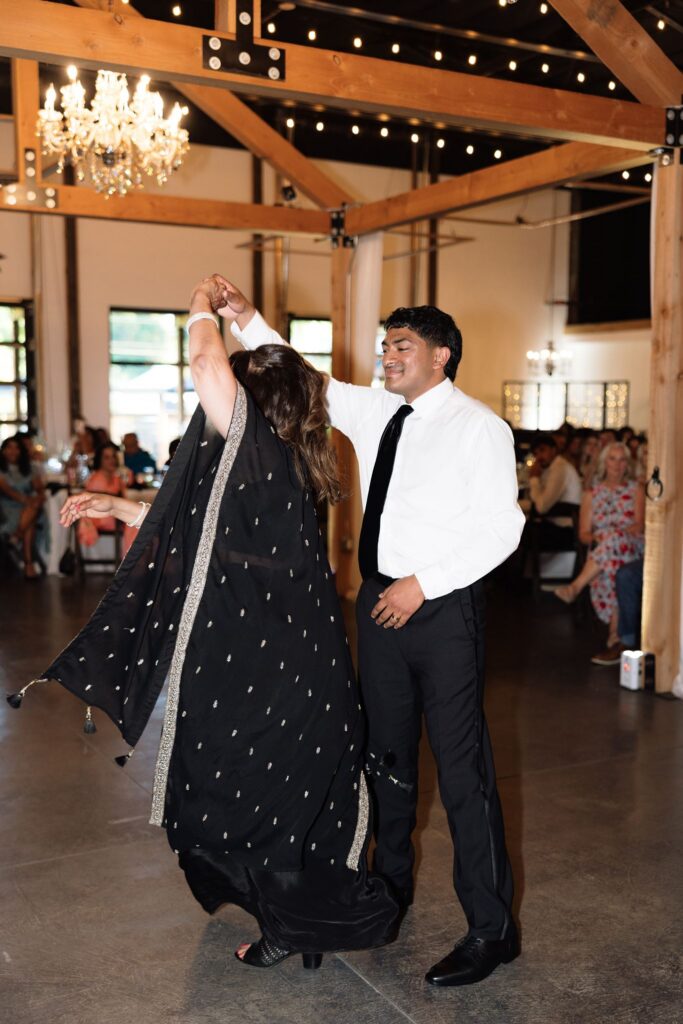 portrait of the groom and his mom dancing a the reception