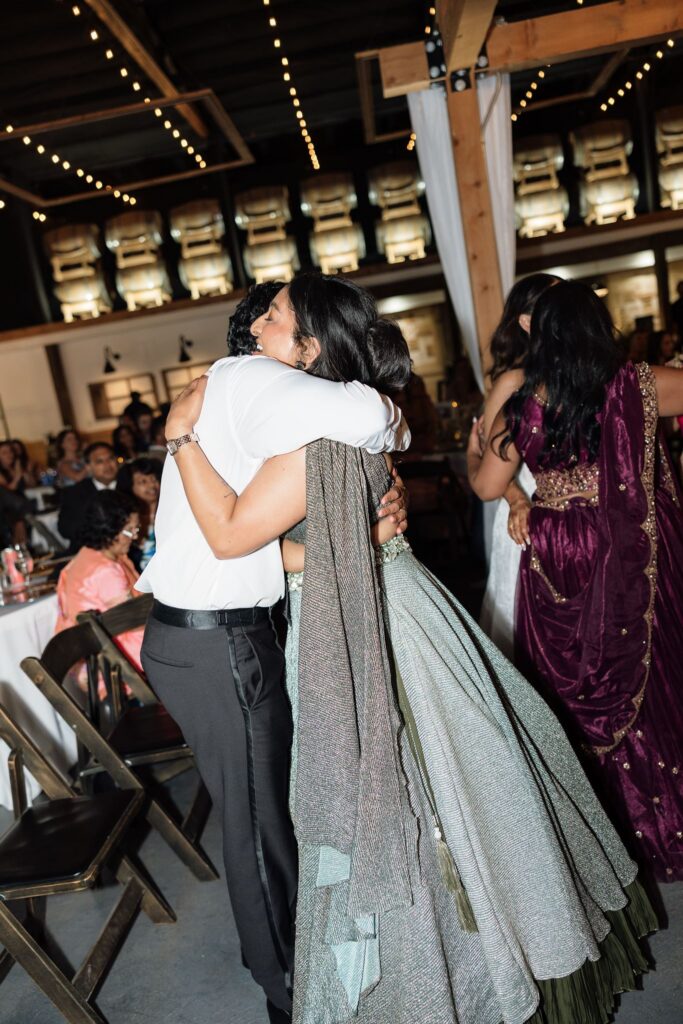 cute picture of the groom hugging his wedding guests