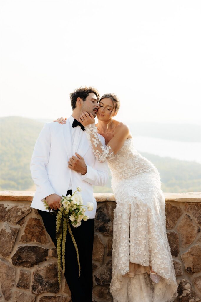 groom kissing the bride on the cheek