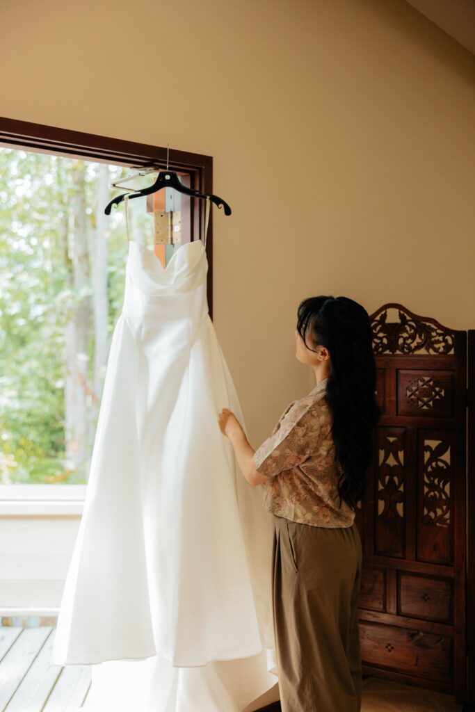 cute picture of the bride next to her wedding dress