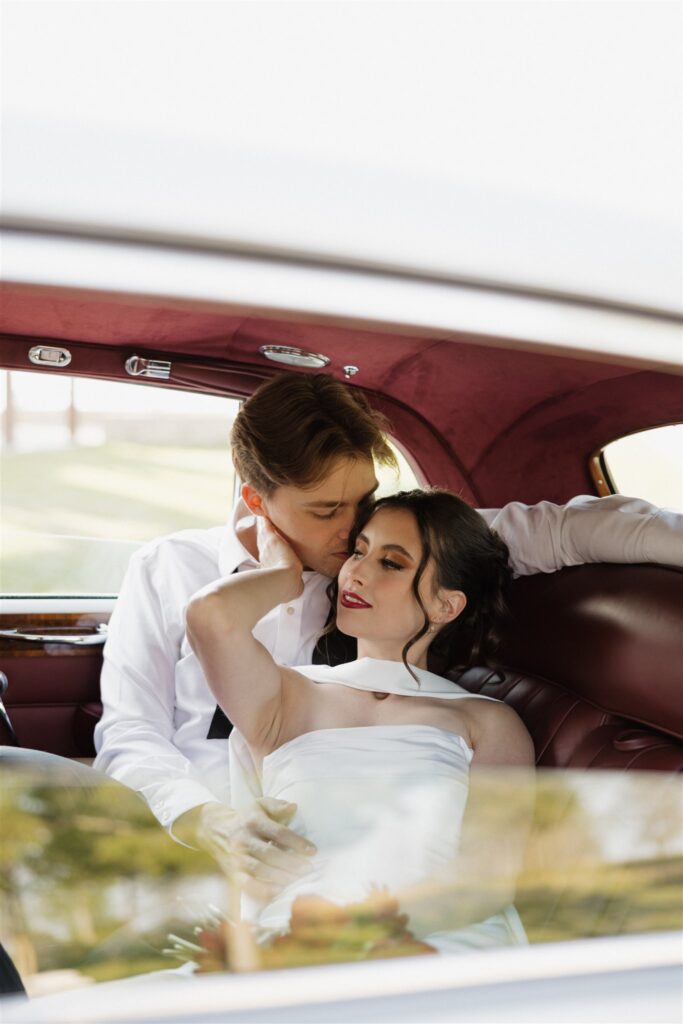 Groom, kissing the bride on the forehead