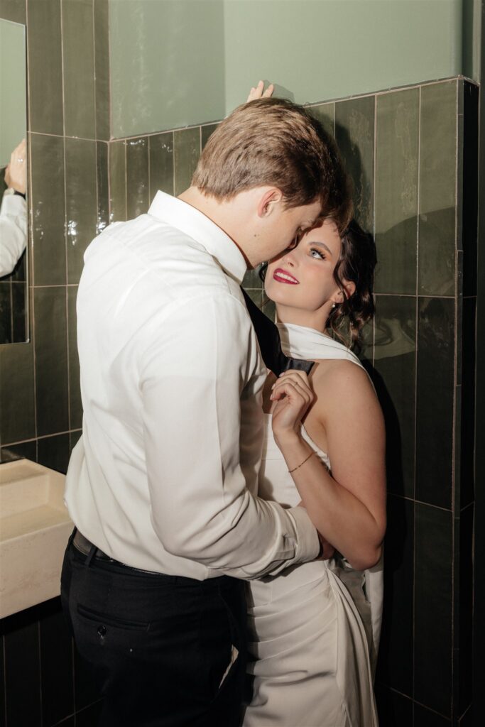 Groom, kissing the bride on the cheek