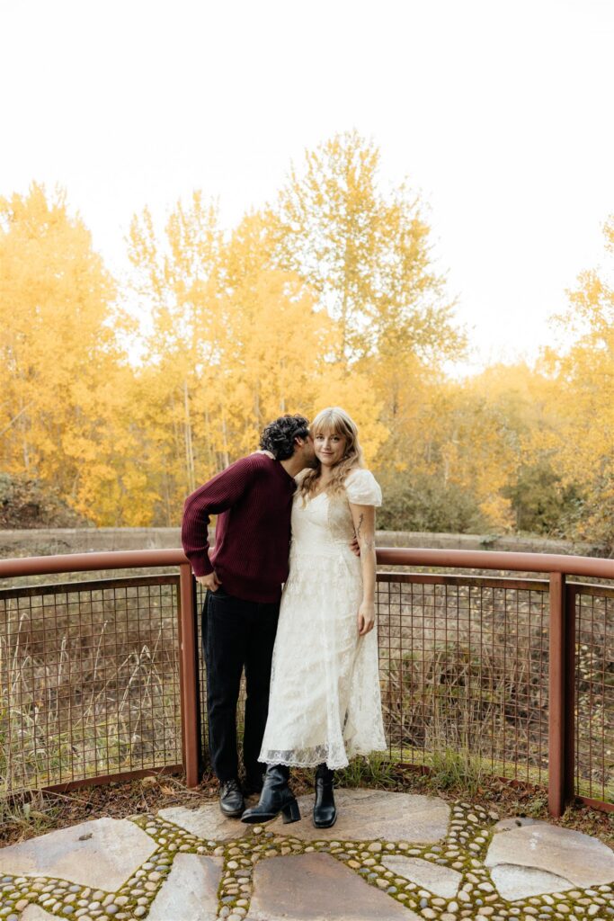 fiance kissing his fiance on the cheek