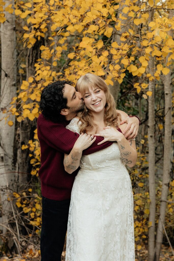 fiance kissing his fiance on the cheek