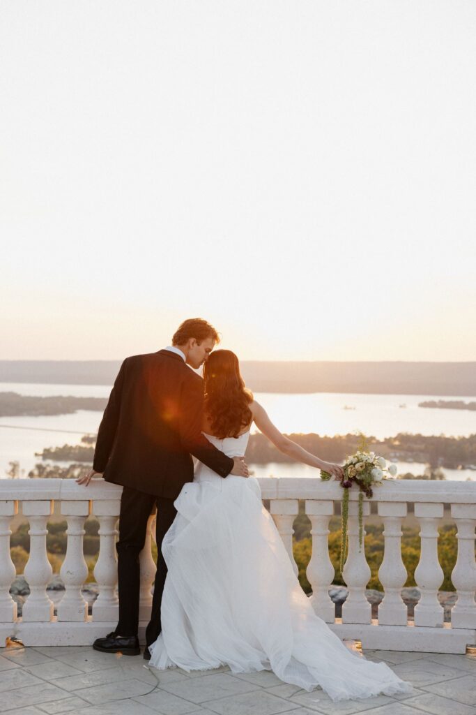 groom kissing the bride on the forehead