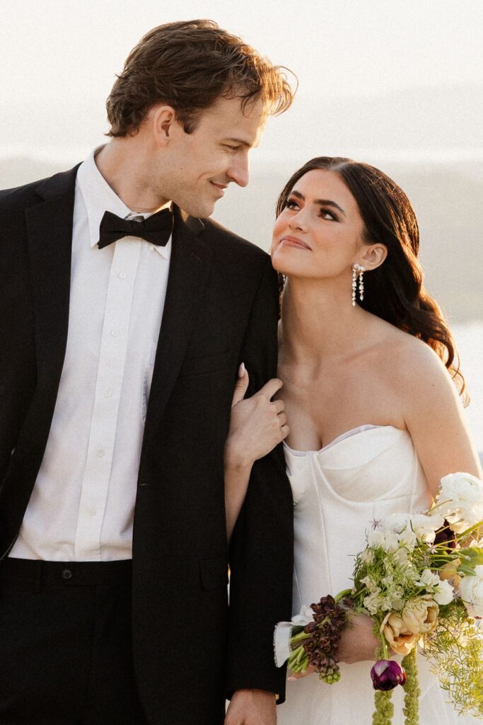 portrait of the bride and groom smiling at each other