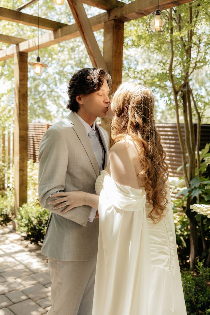 cute picture of the bride and groom kissing