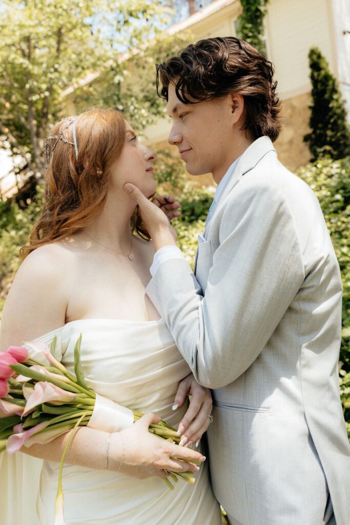 newly married couple smiling at each other during their bridal session
