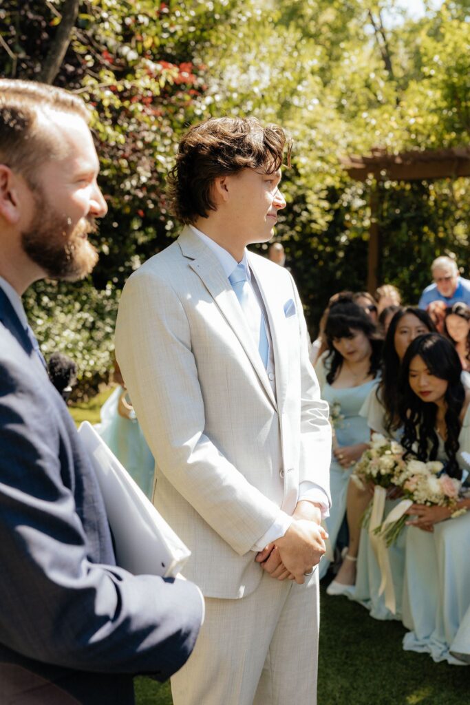 groom watching the bride walk down the aisle
