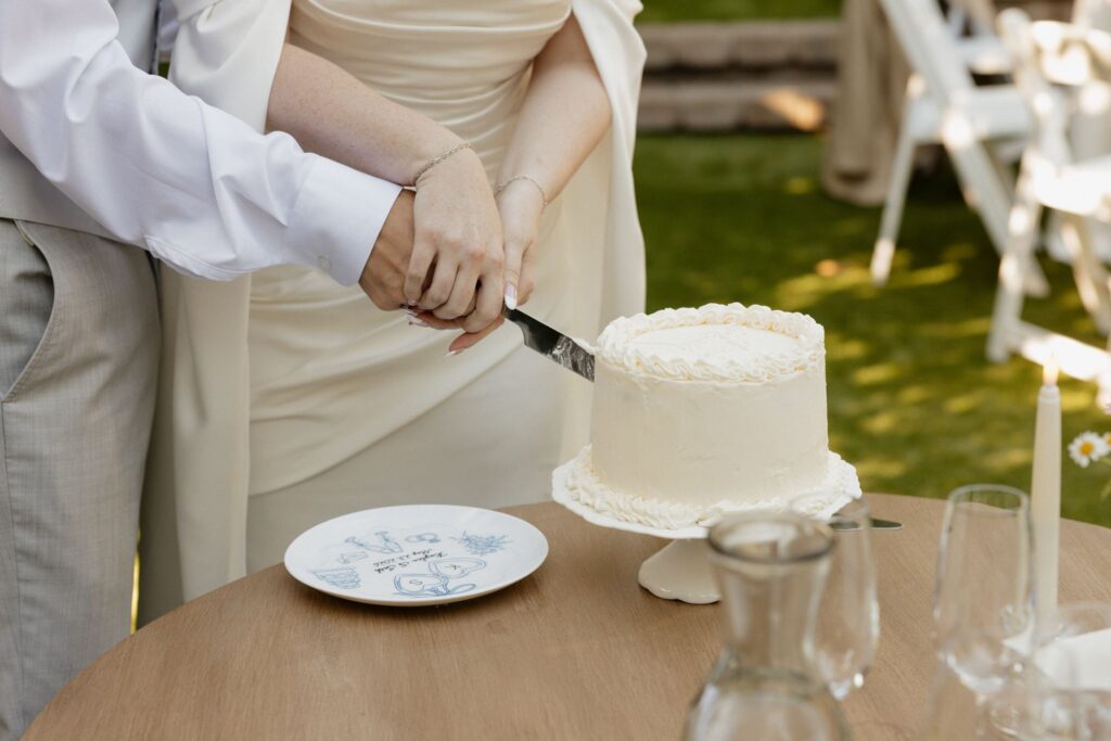 newlyweds cutting their wedding cake