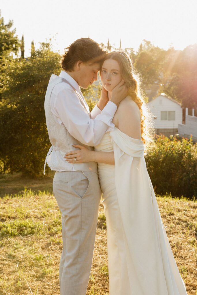 groom kissing the bride on the cheek